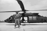 Afghanistan - A Marine stands in front of a helicopter.