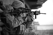 Afghanistan - A Marine aims his rifle