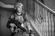 Afghanistan - A Marine stands in a house.