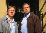 Stefan Kehler (Wolfgang Bathke, re.) und der Drogeriebesitzer Paul Borowski (Raimund Gensel) sind dabei, als in der abgebrannten Drogerie die Leiche einer Frau gefunden wird.