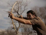 Hazen Audel with a bow and arrow. The San use bows to shoot lethal poisoned arrows into their prey.