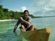 Hazen paddling in his newly fashioned traditional canoe made from the breadfruit tree.