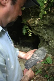 OKINAWA, JAPAN- Tony Pollard with the sole of a split-toe 'Tabi' (a shoe that would have been warn by elite Japanese troops) which he found in an artillery cave. (Photo credit: DSP)