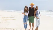 (L to R) Mentors Alison Victoria, Ty Pennington and Taniya Nayak pose together on the beach, as seen on Battle on the Beach, Season 3.