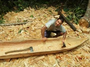 Hazen working on his dug out canoe.