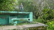 Papua New Guinea - Marty Morgan on Japanese gun emplacement at Submarine Base, Rabaul. (National Geographic/Martin Kemp)