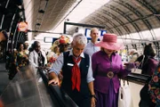 Gusta greets two ladies upon the arrival of the Keti Koti train in Amsterdam, Netherlands. (National Geographic)