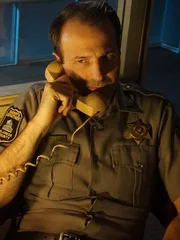 Steve on the phone at the police station where he worked.