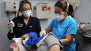 Dr. Lee and assistant operate on David's neck.