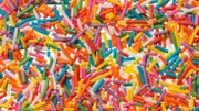 Background from confectionery confetti for food decoration what using in Easter