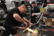 At Paul Jr. Designs, Brendon fabricates part of the exhaust for the Martin Guitar reverse trike.