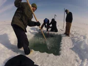 Crew digs a dive hole.