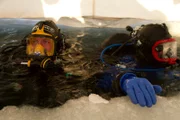 Emily Riedel and her father Steve prepare to go under the ice to dredge for gold.