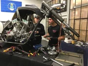 Paul Teutul, Jr. gets help with wiring on the TrüNorth bike from his intern, Shaun.