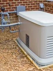 A home generator that provides electricity during a power outage. It is connected to a propane gas supply.