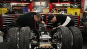 Junior and Ryan work on assembly of the MyTruckWarranty.com trike.
