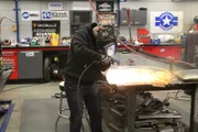 Sparks fly as Lead Fabricator Josh works on a fender.