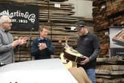 At the unveiling of the Martin Guitar reverse trike, Chris Martin and Tim Teel present Paul Junior with the guitar he designed.