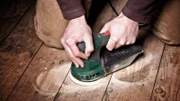 closeup of carpenter work with sander on wood floor