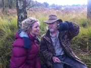 England, UK: Suzannah Lipscomb with herpetologist Mark O Shea and an adder.  (Photo credit: National Geographic Channels)