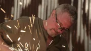 J cutting metal under frame, sparks flying up