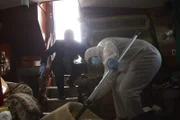 Forensic analyst and Robillard inspect crime scene