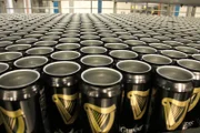 Belfast, County Antrim BT5 6SL, UK - Empty Guinness cans are loaded into the filling lines. First they are given an air wash.