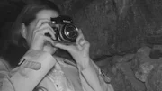 A woman takes a picture with a camera