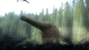 A Titanosaur with giraffe-patterned skin cranes its long neck. The Titanosaur is likely the largest creature to ever roam the earth, weighing over 100 tons.