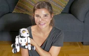 Anna und ihr neues Haustier, der Roboterhund Zoomer.
