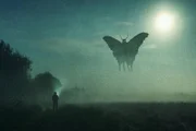 Ein Horror-Konzept. Ein Mann, der ein mysteriöses Monster, ein Mottenmännchen, am Himmel fliegend betrachtet. Silhouettiert gegen den Mond in der Nacht. Mit einem Grunge, texturiert bearbeiten.