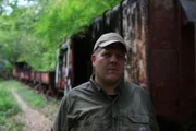 Mark Waycaster examines Malayan Box Car and Carriagees in Jungles of Sai Yok, Thailand.