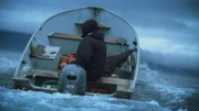 Mary Miller heads out in her skiff while a storm brews in the distance.