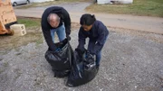 Recreation Photo – Det. Flavell and Officer Drummond search bags from the dumpster.