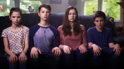 The Fuss children sitting on the couch.