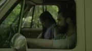 A couple sits in a car.