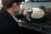 NewCastle-upon-Tyne, UK - Young man Anthony Walker wiping clean a plaque on a steam train engineered by the Stephenson and Company, which was the worlds first locomotive builder.