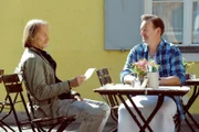 Sascha (Eisi Gulp, links) schlägt Gregor (Holger Matthias Wilhelm, rechts) vor, beim Schreiben des Liebesgedichts die KI zur Hilfe zu nehmen.