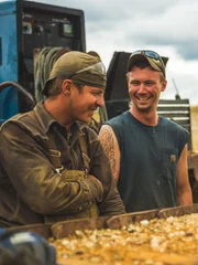 Tony, Brandon and Kent laughing together with feeder in frame.