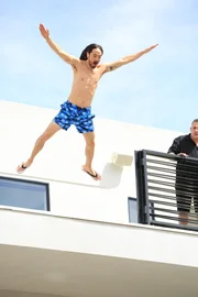 Steve Aoki jumping into his 16 foot pool.