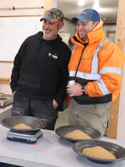 Doumitt and Mitch smiling at gold.
