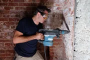 Rob Nelson drills through a wall in tunnels underneath Denver's downtown.