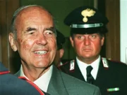 Former Nazi officer Erich Priebke, left, arrives in a Rome Military Court followed by a Carabinieri Italian paramilitary police officer, for a hearing in his trial.