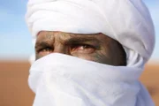 MOROCCO- Hazen wearing traditional Burba dress with blue and purple powder on his face called Indigo. Its used by locals to protect from sun and glare.