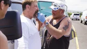 Casey gluing Johnathan's tooth back into place on the side of the road.