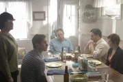 McCrary Family sitting at dinner table and eating during reenactment.