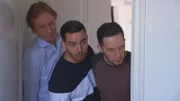 Drei Männer verstecken sich und beobachten etwas
