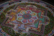 Spiti Valley, Northern India - A completed sand mandala in a Tibetan Buddhist monastery, 15,000 feet above sea level in the Spiti Valley in India. Eight monks spent days painstakingly and meditatively laying down colored sand in intricate patterns. Following a time of puja, or prayer, the mandala will be destroyed – a dramatic symbol of the transient nature of life.