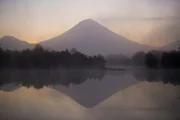 Kamchatka, Eastern Russia - The sun begins to rise behind an active volcano in far Eastern-Russia. Sometimes known as the “Land of Ice and Fire”, the Kamchatka peninsula is home to the greatest concentration and diversity of Salmonid fish on Earth.