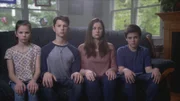 The Fuss children sitting on the couch.